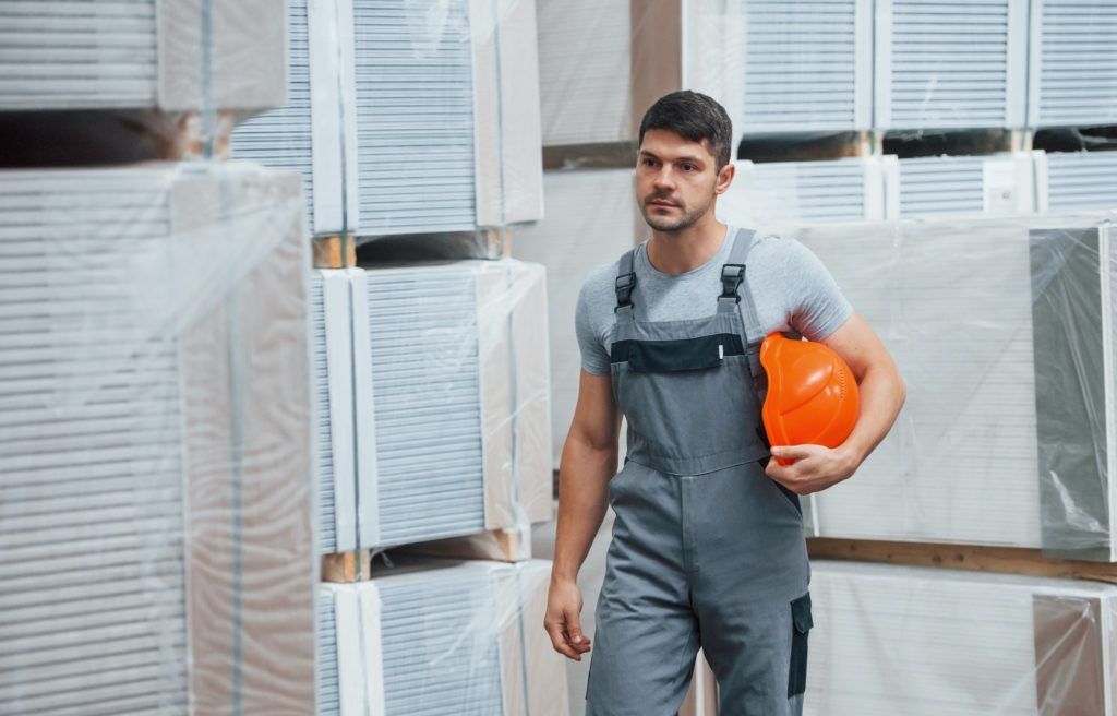 Portrait of young worker in unifrorm that is in warehouse